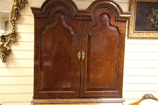 A Queen Anne walnut and featherbanded bureau cabinet, W.3ft 5in.